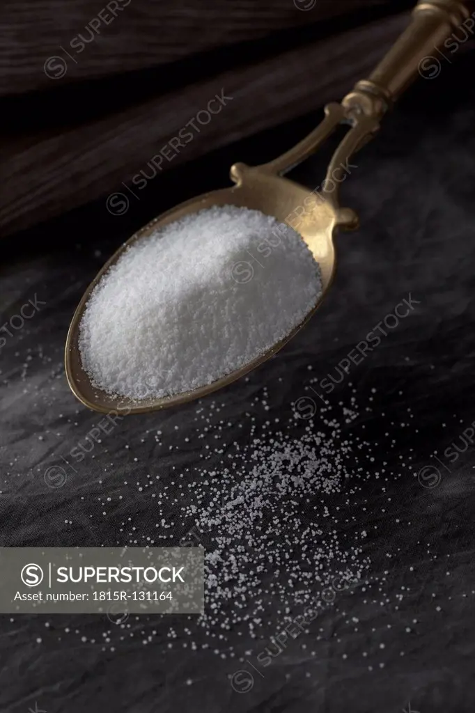 Salt on brass spoon, close up