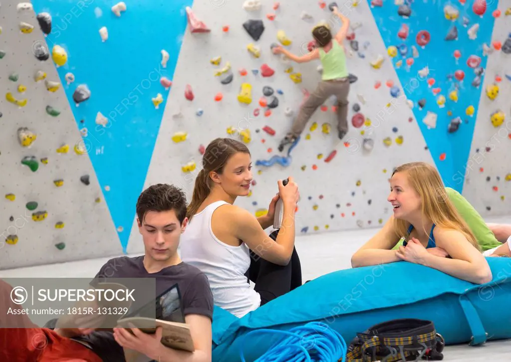Friends relaxing together, indoor climbing