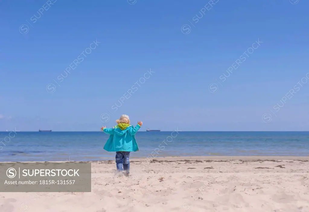 Germany, Mecklenburg Western Pomerania, Boy playing with sand at baltic sea