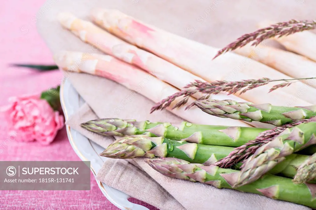 Asparagus officinalis on plate with flower, close up
