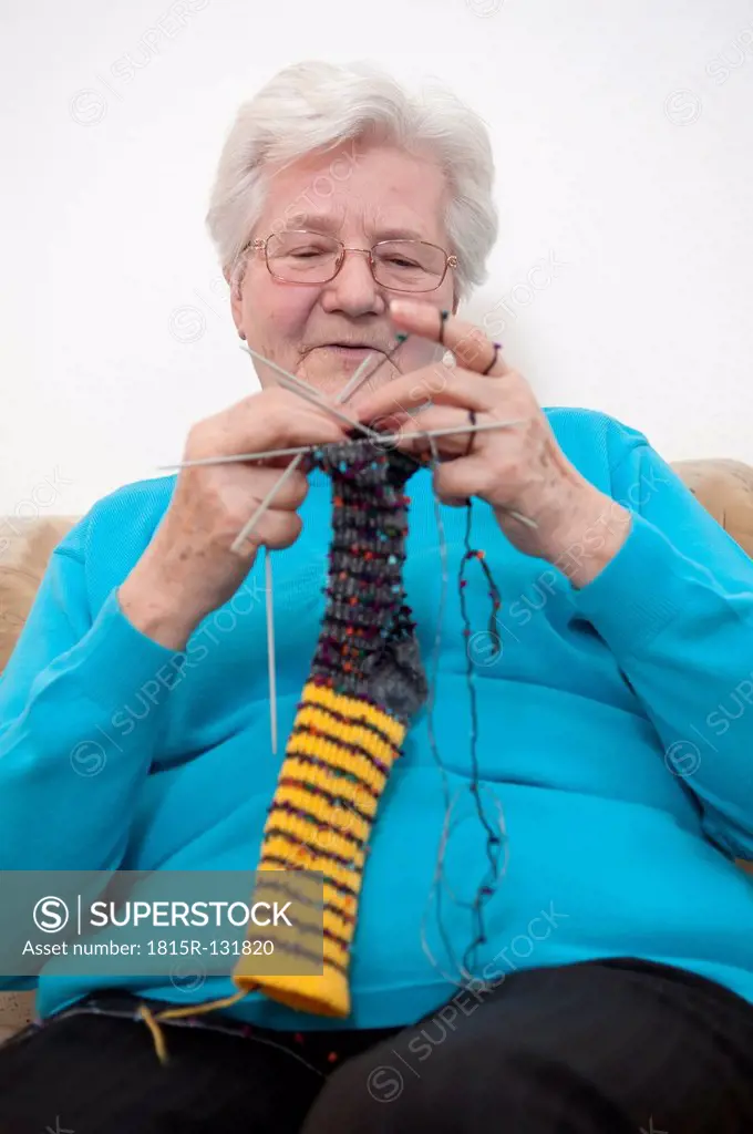 Germany, Berlin, Senior woman knitting socks, close up