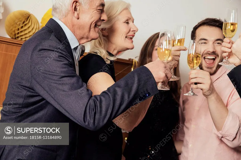 Friends celebrating New Year's Eve together, drinking champagne