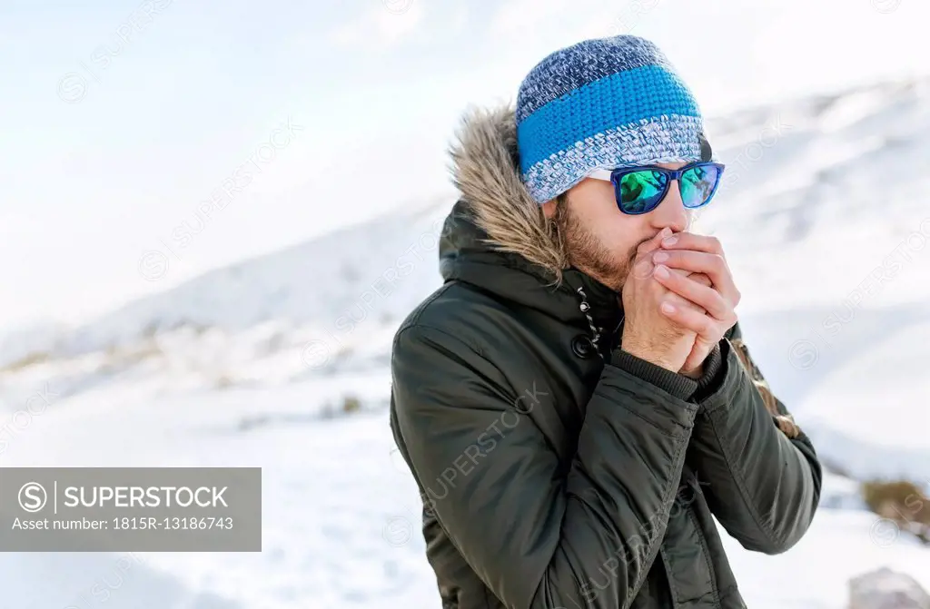 Spain, Asturias, freezing man in snowy mountains