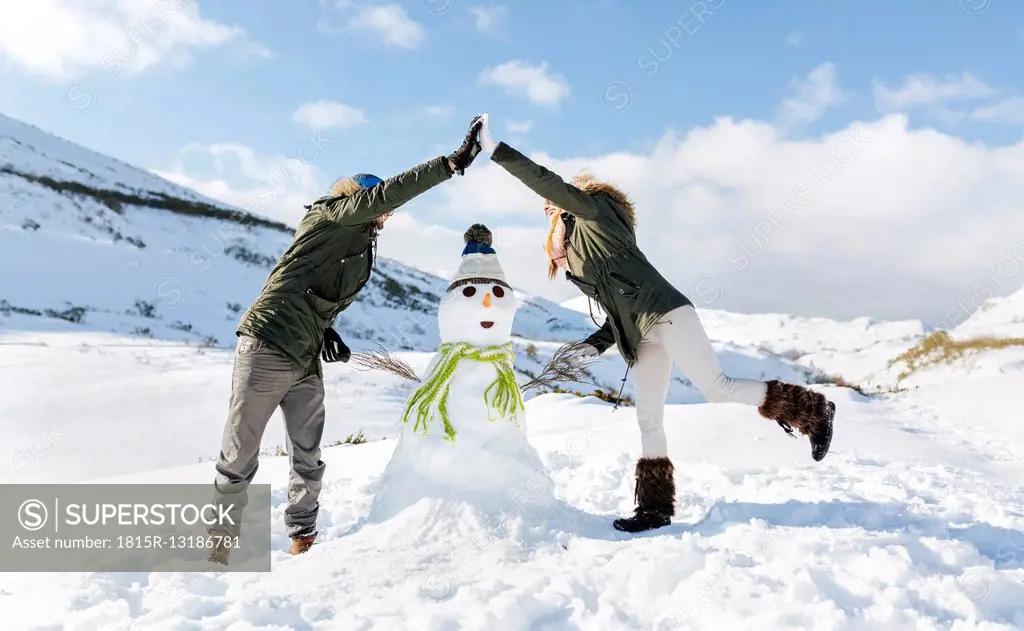 Spain, Asturias, couple with a snowman