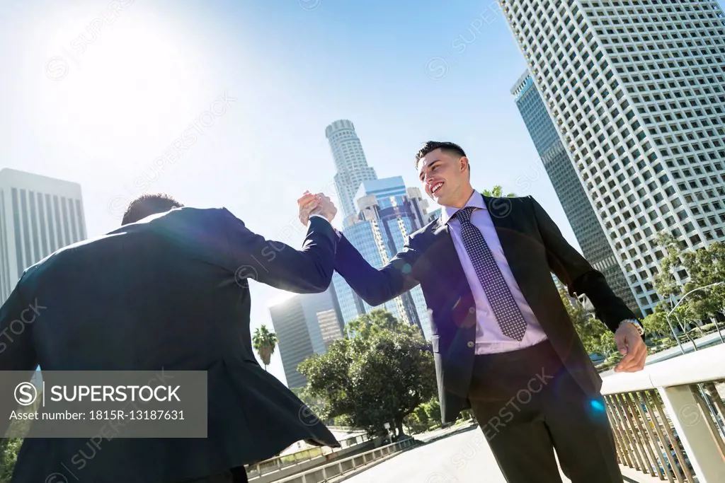 USA, Los Angeles, two businessmen high fiving