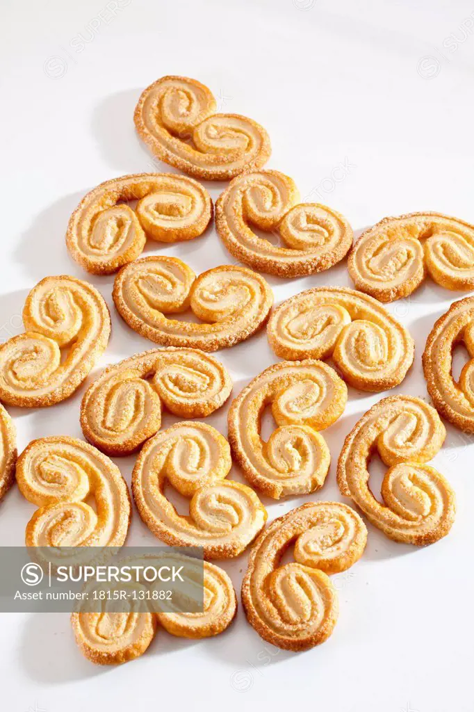 Pigs ears pastries on white background, close up