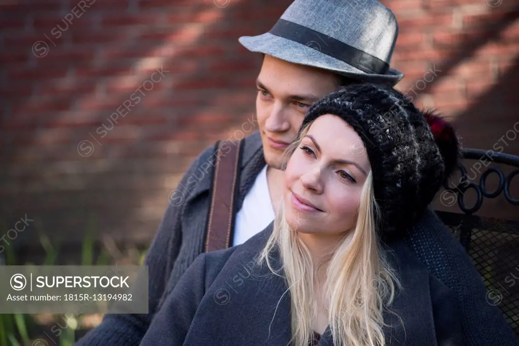 Portrait of relaxed woman with her boyfriend in the background
