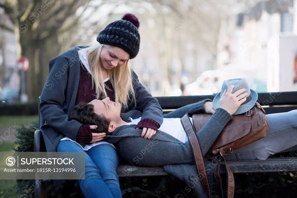 Young couple in love together on a bench