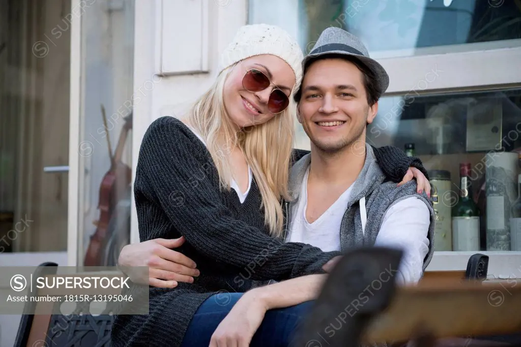 Portrait of couple in love sitting on a bench