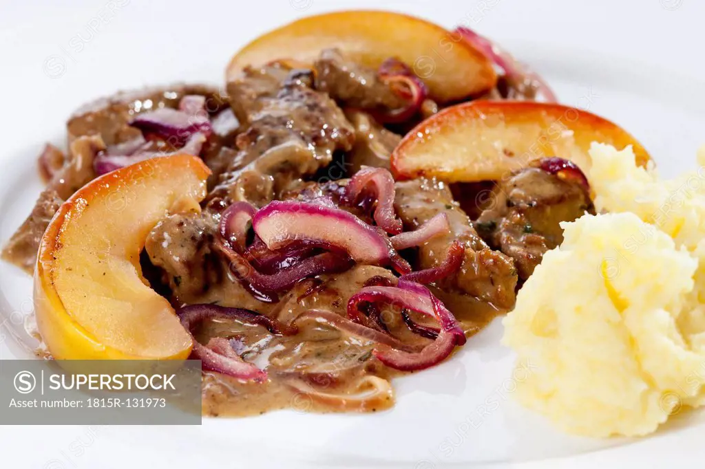 Plate of calf's liver, mashed potatoes, mushrooms, onion and glazed apples, close up