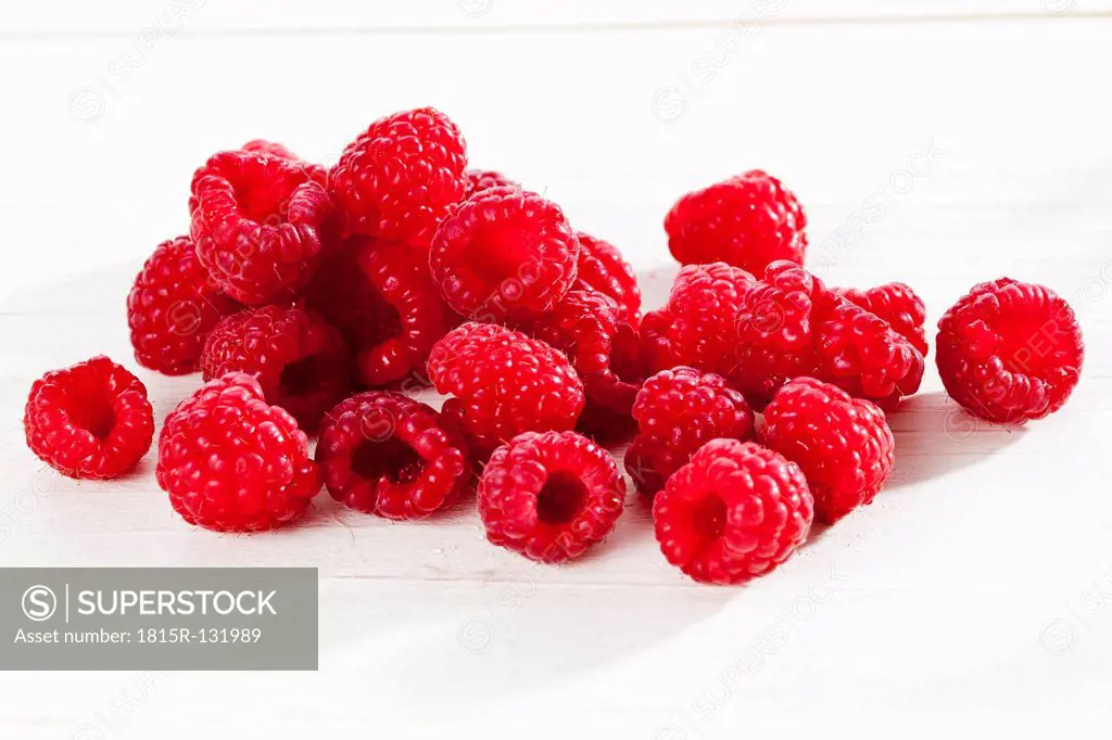Raspberries on white background, close up