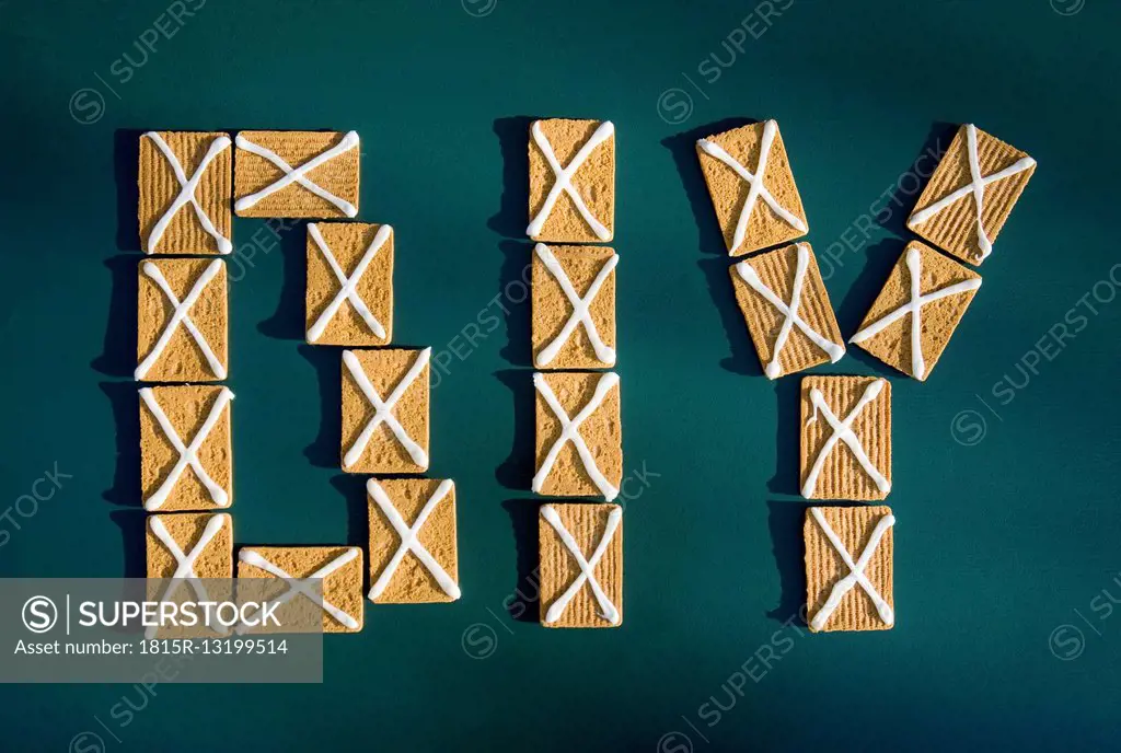 Letters DIY built of biscuits with icing on green ground