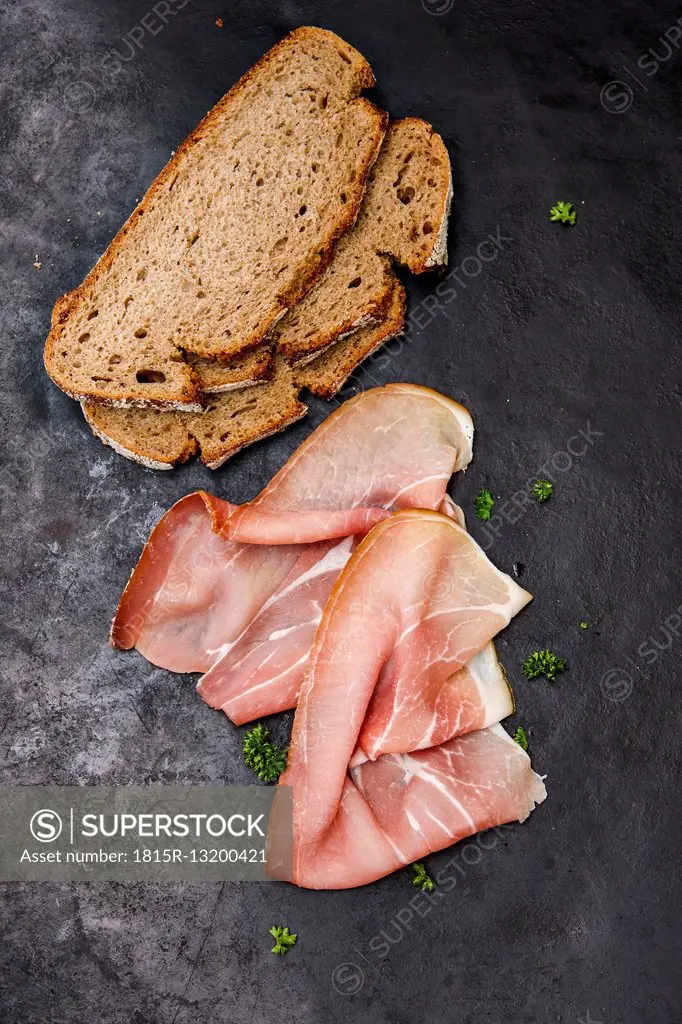 Slices of raw ham, bread and parlsey