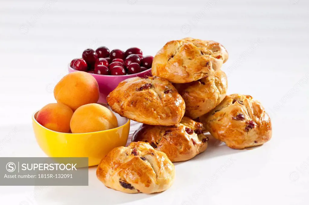 Cranberry scones with apricot on white background, close up