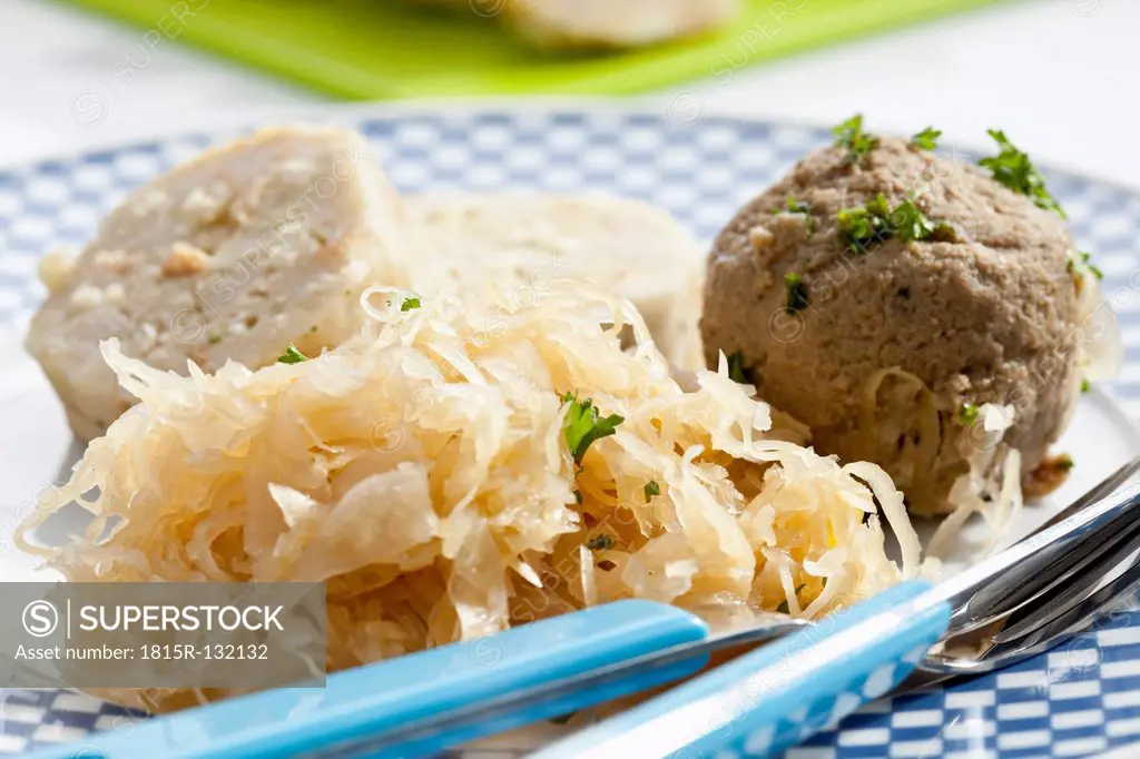 Plate of bread and liver dumpling with sauerkraut, close up
