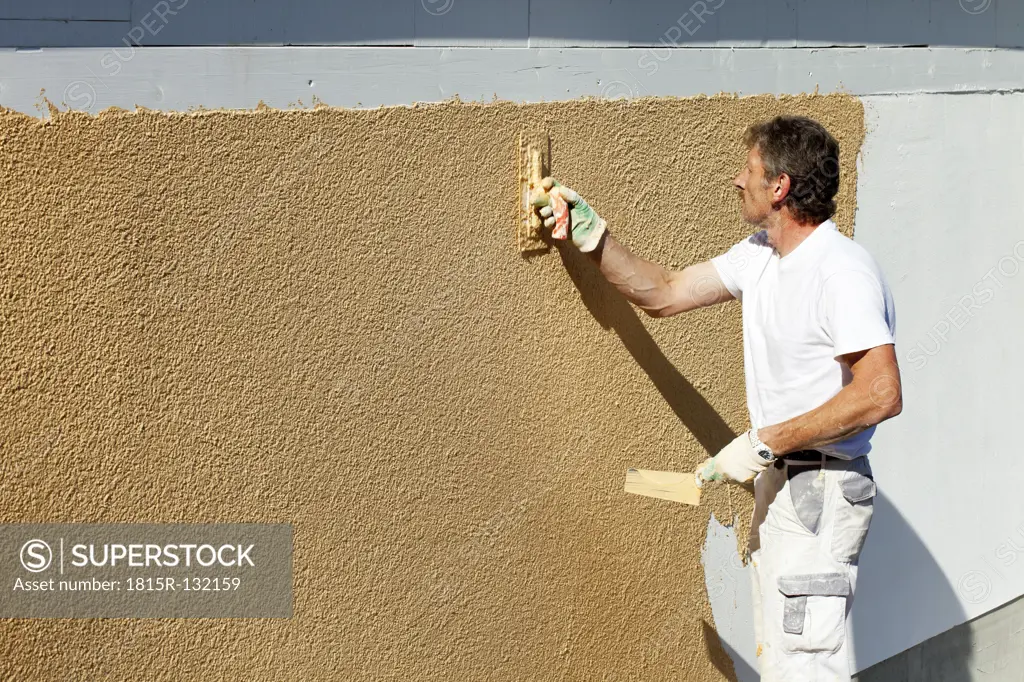 Europe, Germany, Rhineland Palatinate, Man plastering house wall