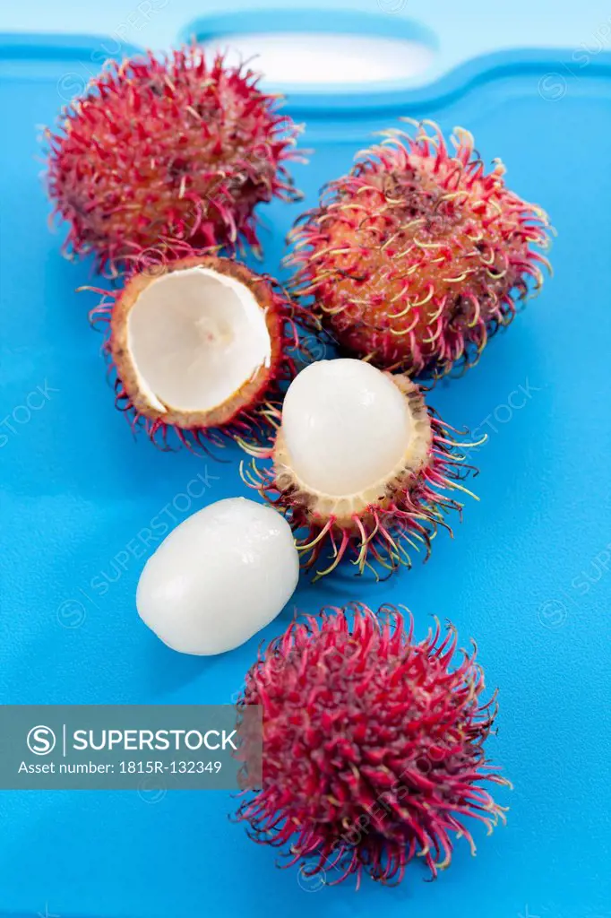 Rambutan fruits on chopping board, close up