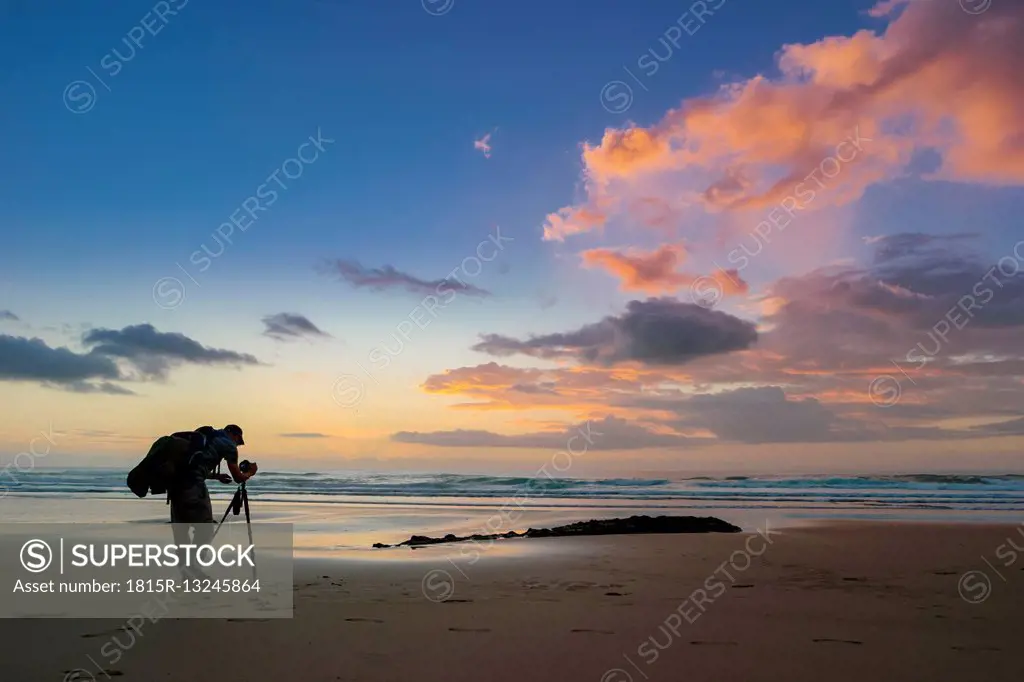 Portugal, Algarve, Aljezur, beach in the evening, photographer at atlantic coast