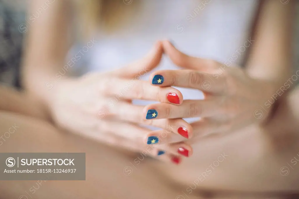 Hands of woman with different varnished nails
