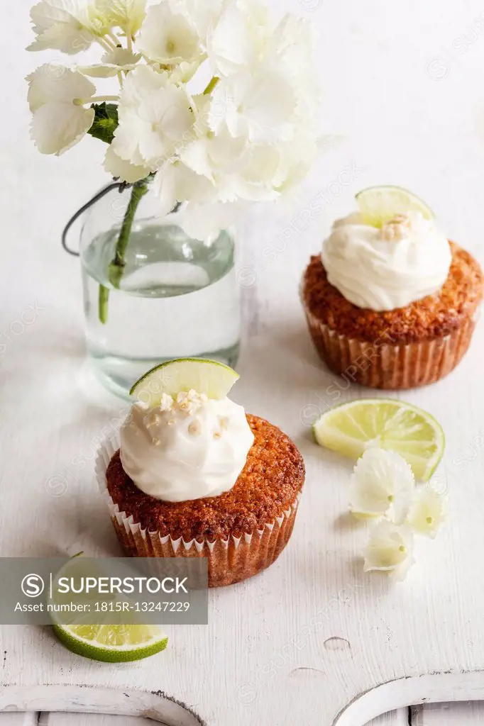 Two lime cup cakes with cream cheese topping