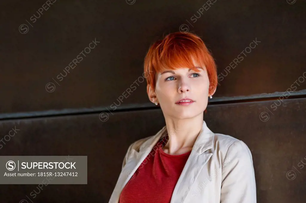 Portrait of redheaded young woman thinking