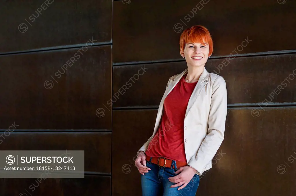 Portrait of smiling redheaded young woman
