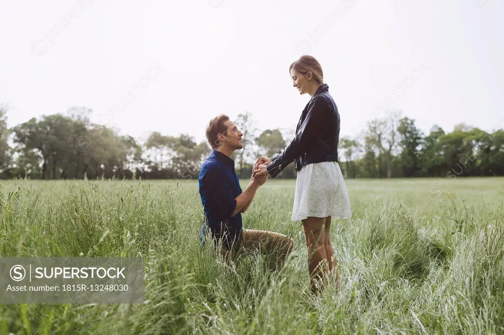 Man proposing marriage to young woman