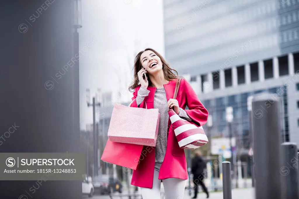 Young woman in the city using mobile phone