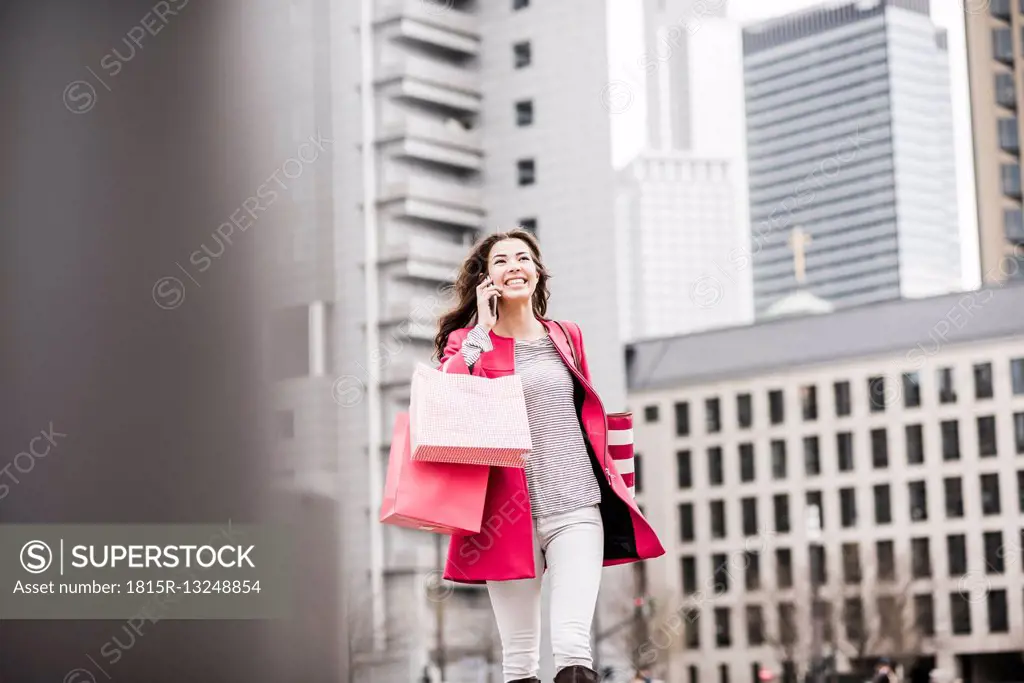 Young woman in the city using mobile phone