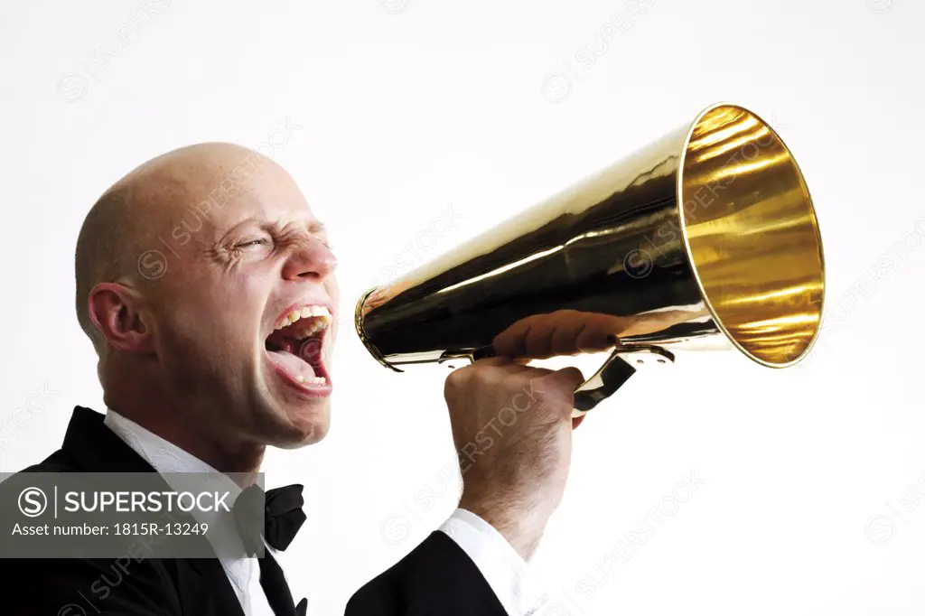 Man shouting into megaphone, side view, close-up