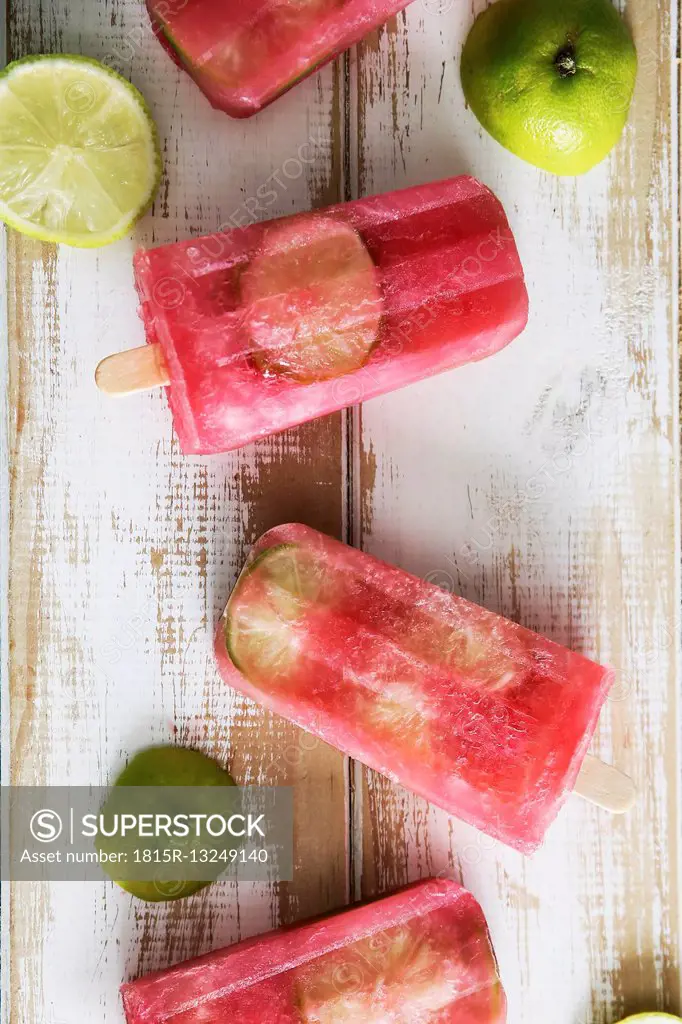Beetroot and lime ice lollies on wood