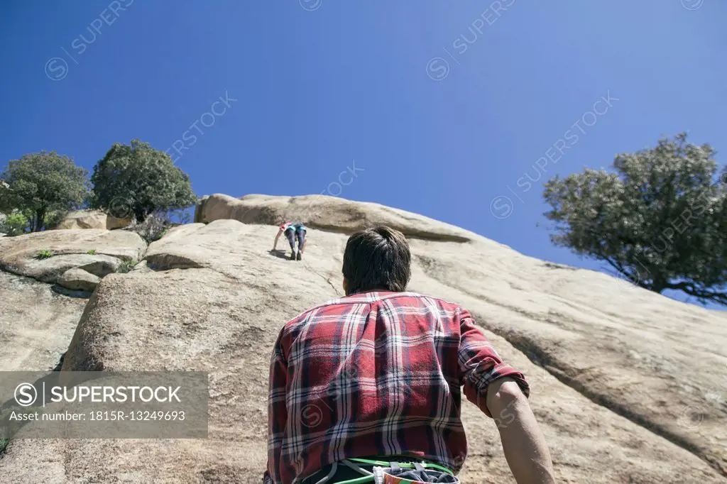 Climber securing a climber woman during climbing