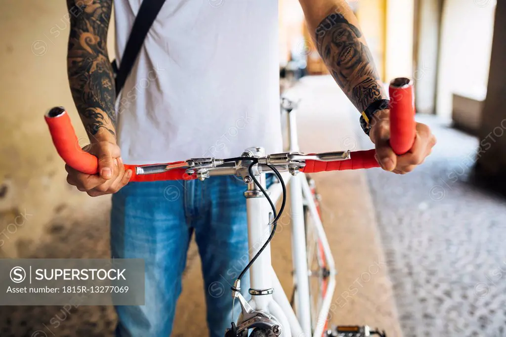 Young man with a bicycle in the city