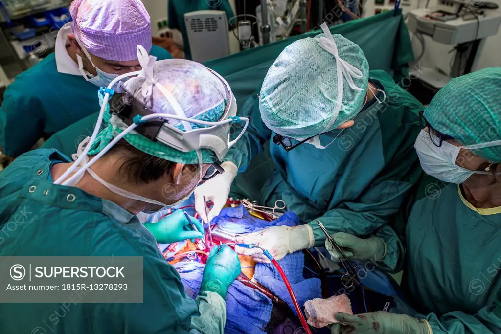 Heart surgeons and operating room nurse during a heart valve operation