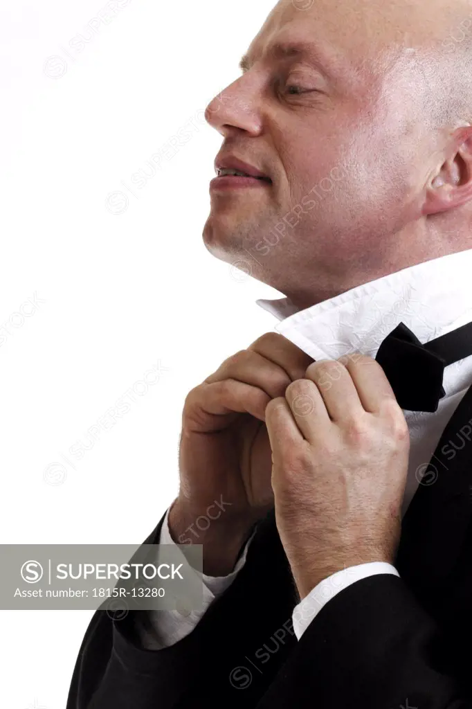 Man binding bow-tie, portrait