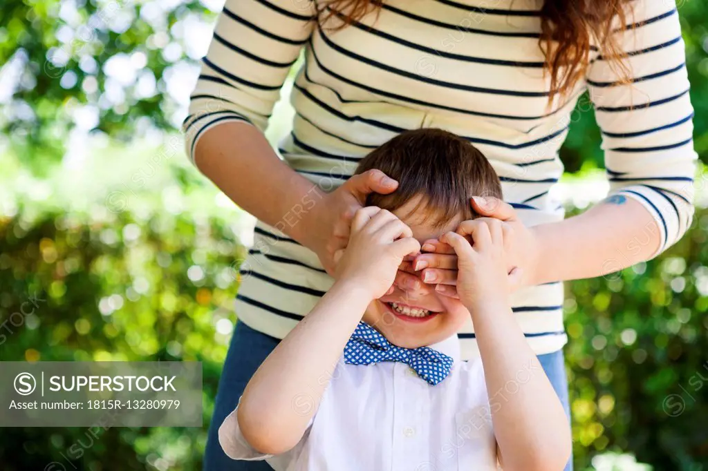 Mother covering son's eyes
