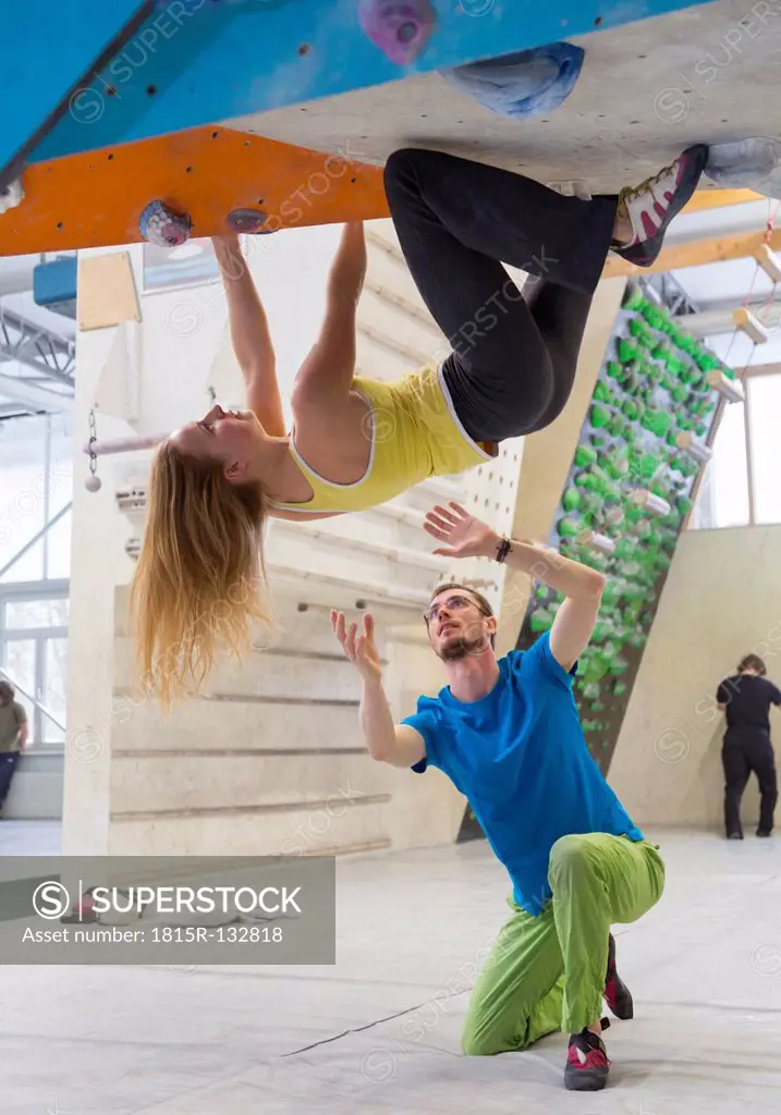 Germany, Bavaria, Munich, Young man helping woman to climb