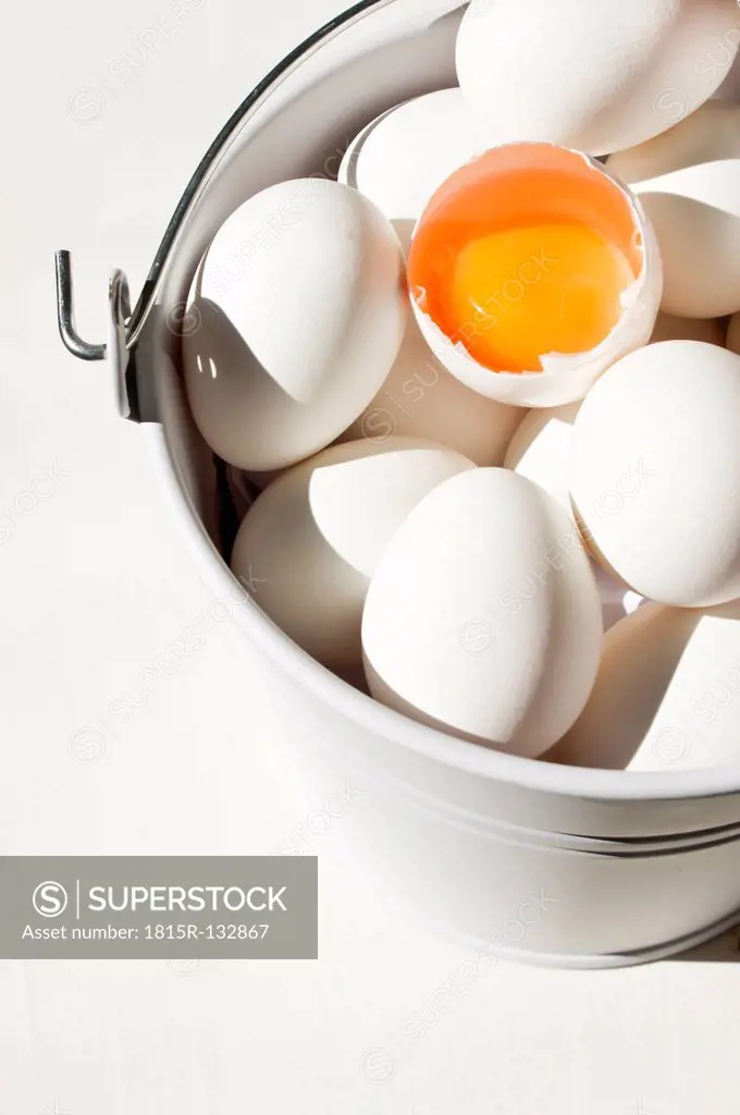 Bucket of white eggs with egg yolk