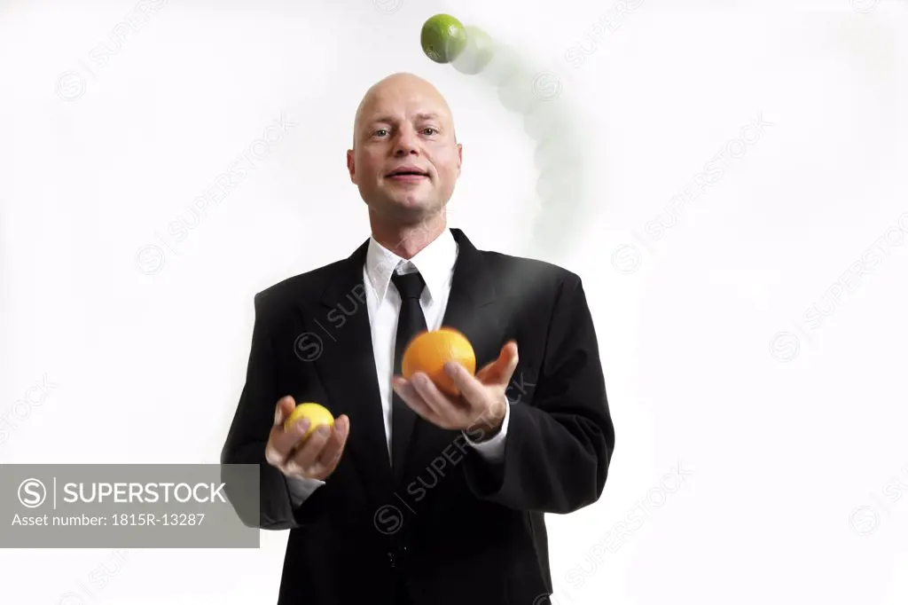 Business man juggling with balls