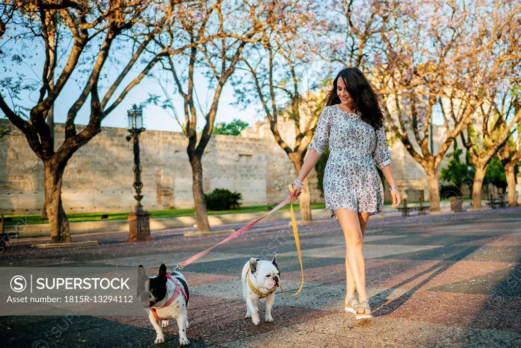 Woman walking her two dogs