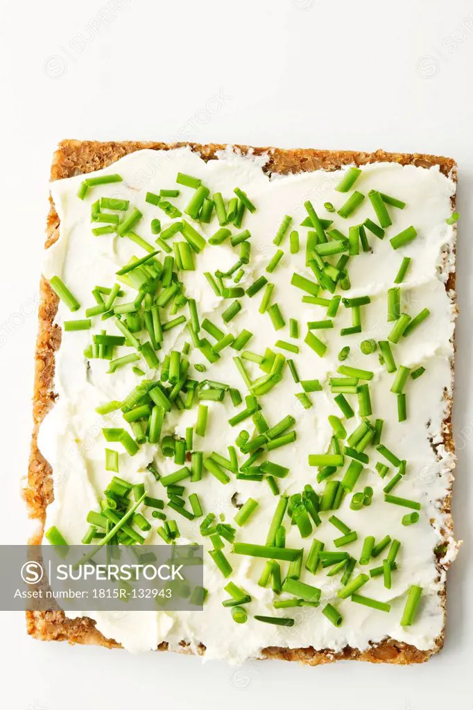 Cream cheese sandwich with chives on white background