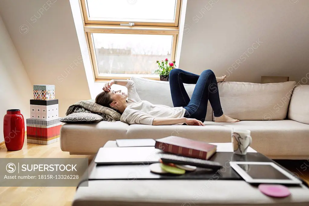 Relaxed woman lying on couch