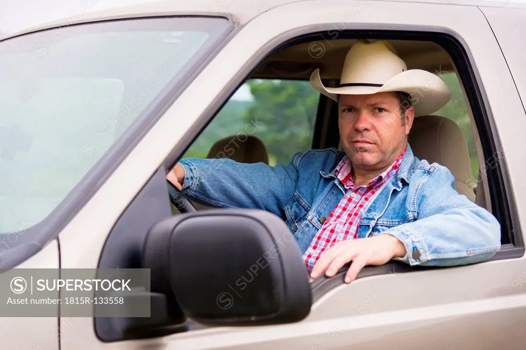 Texas, Mature man with cowboy hat sitting in pick up truck