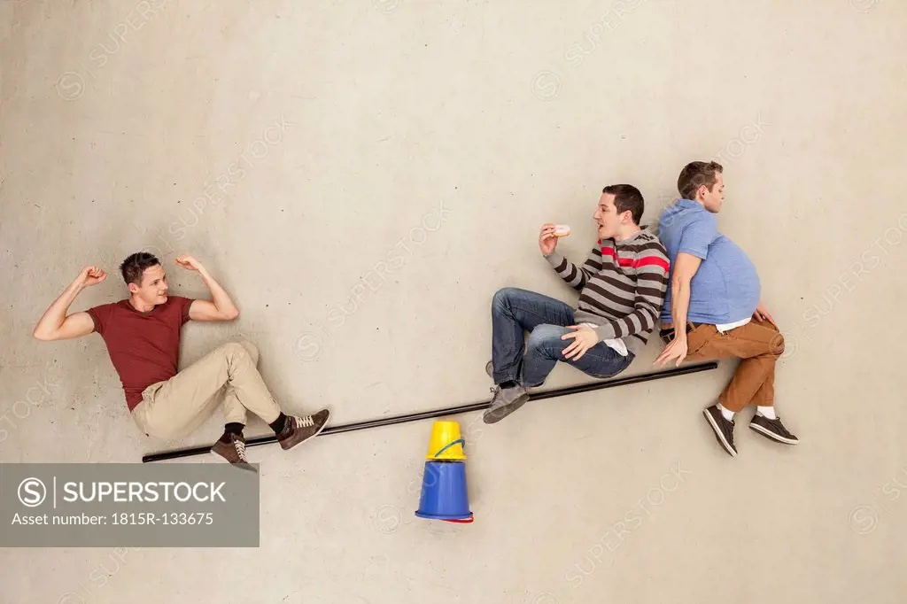 Men on seesaw and eating food