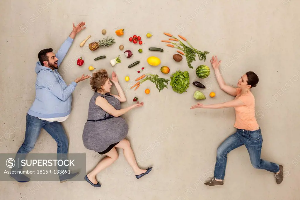 Men and woman with food against beige background