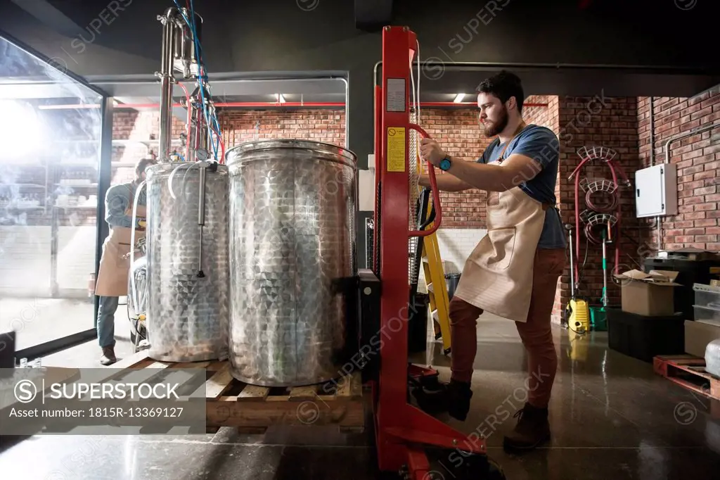 Two men working in distillery