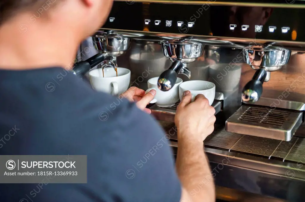 Man preparing coffee at coffee machine