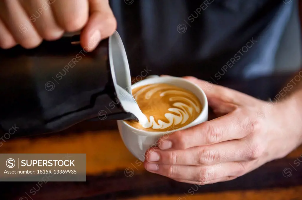 Barista preparing cappuccino in a cafe