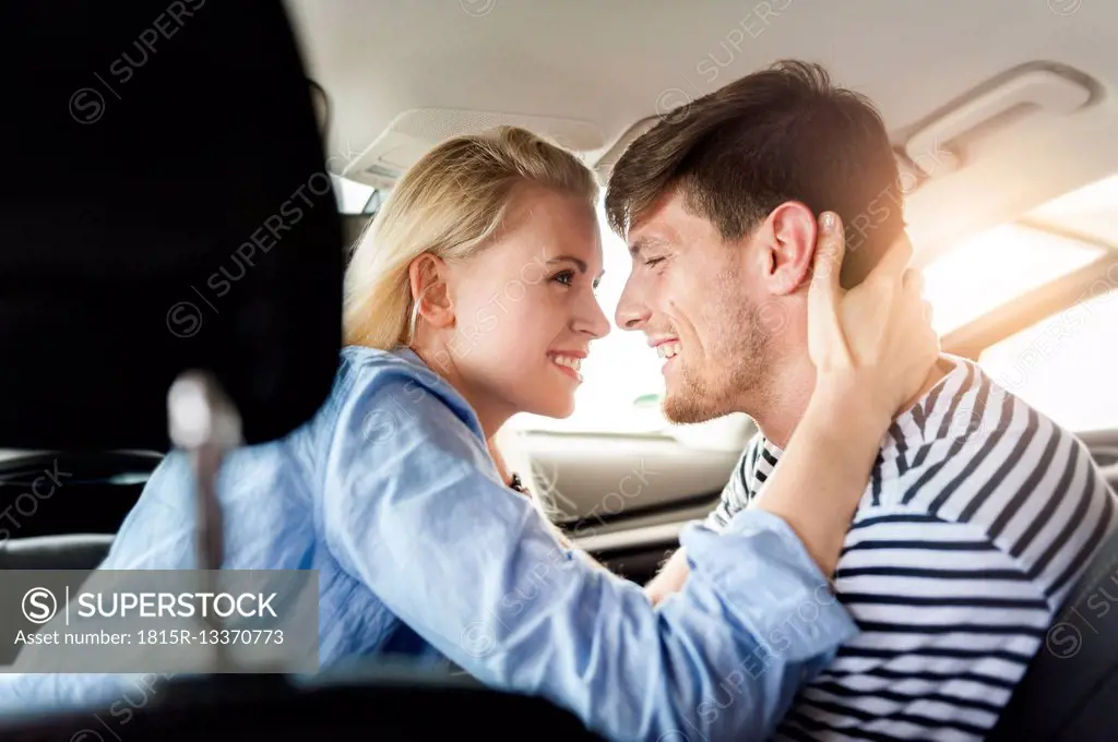 Smiling couple in love in a car
