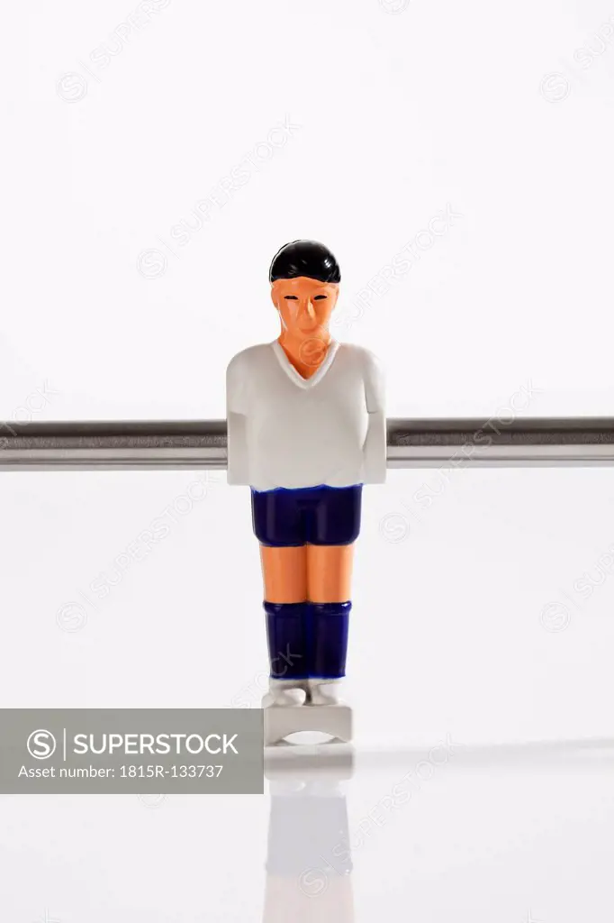 Figurine of table football against white background